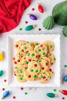 a white plate topped with cookies covered in candy