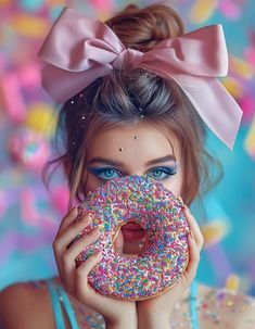 a woman holding up a donut with sprinkles on it's face