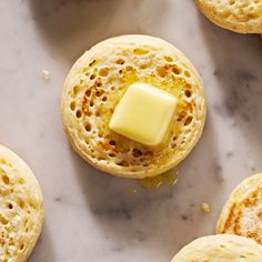 some food that is on top of a white counter with yellow butter in the middle