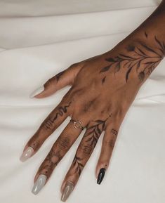 a woman's hand with tattoos on it