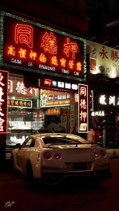 a car is parked in front of a chinese restaurant with neon signs on the building