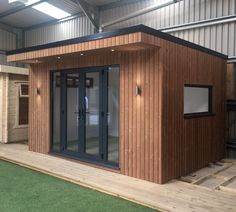 a small wooden building with sliding glass doors