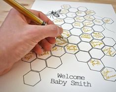 a person writing on a sheet of paper with honeycombs and bees in it