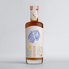 a bottle of whiskey with a tiger on the front and side, sitting on a white surface