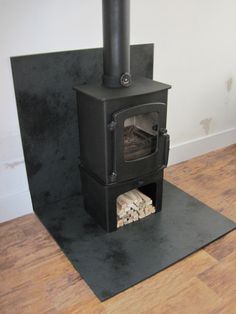 a wood burning stove in a room with wooden floors