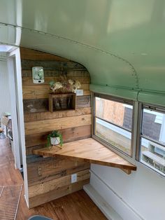 the inside of a tiny house with wood paneling