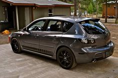 a silver car parked in front of a house