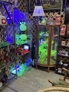 a room filled with lots of different types of items and lights on display in glass cases