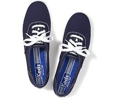 two navy blue shoes with white laces on the top and bottom, against a white background