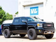 a black truck parked in front of a building