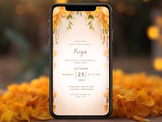 an iphone with the wedding program displayed on it, surrounded by yellow flowers and greenery