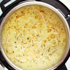 a pot filled with soup sitting on top of a stove