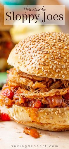 a close up of a sandwich on a wooden table with text overlay reading sloppy joes with crispy onions