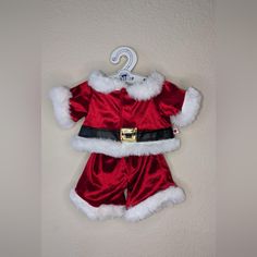 a santa clause outfit hanging on the wall