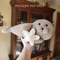 a hand holding a stuffed animal in front of a china cabinet with the caption pattern ppf only