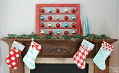 stockings hanging from a fireplace mantel decorated with christmas ornaments