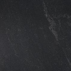 a black granite counter top with white dots on it