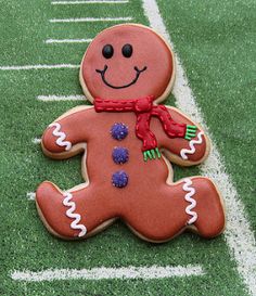 a decorated ginger sitting on top of a green field next to a white soccer field