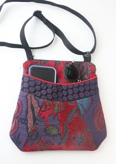 "Medium sized purse, perfect for a quick errand or a full day out! This purse has two front pockets, perfectly sized for your phone and/or glasses as well as a zippered back compartment large enough to fit a kindle or ipad mini. Each bag is fully lined with a zippered interior pocket. Approximate dimensions: Width at top zipper: 8\", Width at bottom of bag: 10.5\", Height: 10\". Each bag is made of beautiful and durable upholstery fabric and hand sewn on an industrial sewing machine in our studi Versatile Multicolor Bag With Cell Phone Pocket, Versatile Multicolor Bags With Cell Phone Pocket, Multicolor Shoulder Bag With Card Slots For Travel, Purple Travel Bag With Card Slots, Multicolor Wallets With Cell Phone Pocket For Everyday Use, Pocket Ideas, Drawstring Bag Pattern, Floral Upholstery Fabric, Jean Purses