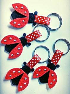 four red and black ladybug keychains with white polka dots on them