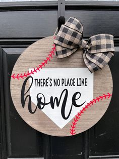 there's no place like home baseball door hanger with plaid bow on it