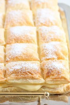 a pastry sitting on top of a pan covered in powdered sugar