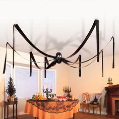 a dining room with a table covered in black ribbon and candles on the fireplace mantel