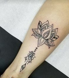 a woman's foot with a lotus tattoo on the left side of her leg