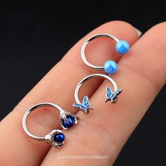 One package includes there pieces blue septum rings. Bar Thickness: 16g(1.2mm); Inner Diameter: 10mm Material: 316L Stainless Steel Blue butterfly,blue dragon claw,blue basic ball Design CBR combination,The combination of this one blue is ubiquitous have small design feeling again already, can match any dress, makeup hair, appear in any occasion. The daith earring is made of 316L Surgical Steel, Hypoallergenic, Nickle and Lead Free, Harmless to Your Piercing and Shorten the Healing Time of Pierc Adjustable Blue Belly Rings As Gift, Nickel-free Blue Cartilage Earrings As Gift, Adjustable Nickel-free Blue Cartilage Earrings, Adjustable Blue Cartilage Earrings, Blue Jewelry With Butterfly Charm For Jewelry Making, Earring Butterfly, Septum Earrings, Daith Earring, Nose Ring Hoop