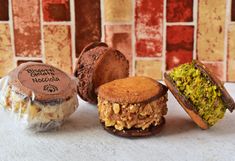 three different types of pastries sitting next to each other in front of a tiled wall