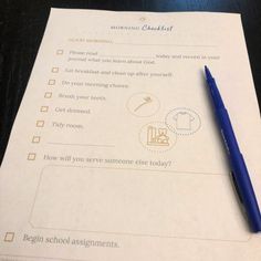 a blue pen sitting on top of a piece of paper next to a checklist