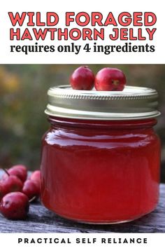 a jar filled with red liquid sitting on top of a wooden table next to berries