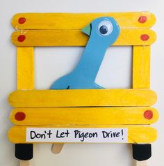 a wooden frame with a blue bird on it that says don't let pigeon dive