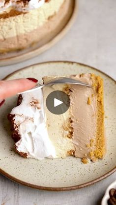 a piece of cake on a plate being held by a person's hand with a knife