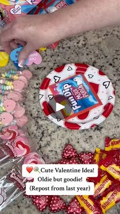 someone is making valentine's day cards with candy