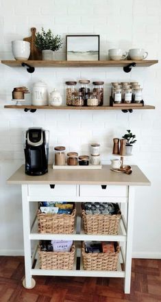 a white table topped with shelves filled with coffee cups and other items on top of it