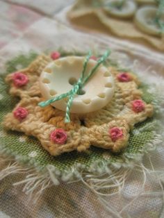 a close up of a piece of fabric with buttons on it and some flowers in the middle