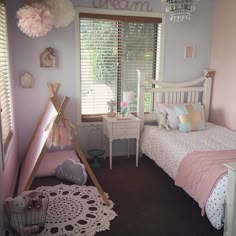 a bedroom with pink walls and white furniture