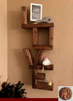 a shelf made out of wooden pallets on the wall next to a potted plant