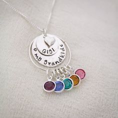 "Personalized Grandma Necklace, Grandmother Necklace, Birthstone Necklace, Love my Grandchildren Necklace, Hand Stamped, Mother's Day Gift This is a perfect Mother's Day Gift for Grandma to show off all of her children or grandchildren. A sterling silver pendant of stacked discs are hammered and hand stamped with her special grandmother name and then bottom disc can be stamped with a special message. A tiny sterling silver heart charm adorns the top of the disc. A sterling silver ring holds all Multicolor Birthday Jewelry With Charms, Multicolor Charm Jewelry For Birthday, Multicolor Charms Jewelry For Birthday, Mother's Day Birthday Gift Charms Jewelry, Charm Jewelry For Mother's Day Birthday Gift, Personalized Multicolor Pendant Jewelry, Nickel Free Round Pendant Jewelry For Mother's Day, Nickel-free Round Pendant Jewelry For Mother's Day, Personalized Multicolor Pendant Necklaces