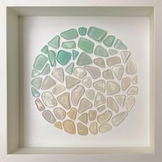 a white frame with some sea glass in it