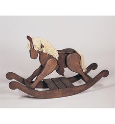 a wooden rocking horse with white manes on it's back legs and feet