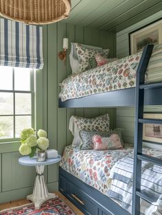 a bedroom with bunk beds and rugs on the floor in front of two windows