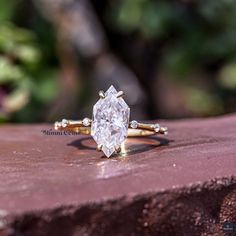 a diamond ring sitting on top of a brick