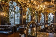 an ornately decorated restaurant with black leather booths