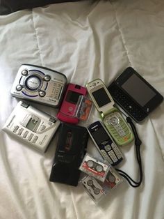 there are many different types of cell phones on the bed