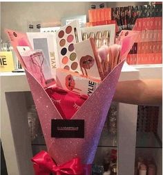 there is a pink vase with makeup on it