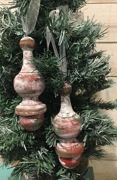 three vases are hanging from a christmas tree