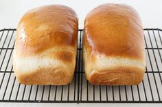 two loaves of bread sitting on a cooling rack