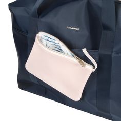 a large blue tote bag with a white zippered pocket and matching purse inside